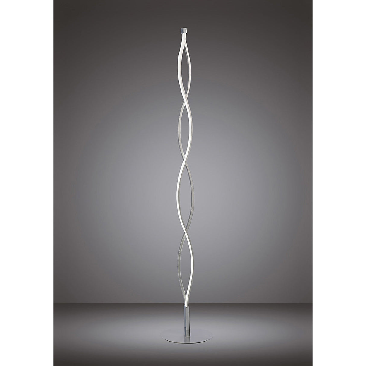 The Sahara LED Floor Lamp 21W 3000K in Silver & Chrome features two intertwined, wavy LED light strips on a round base for stylish ambient lighting, shown against a neutral gray background.