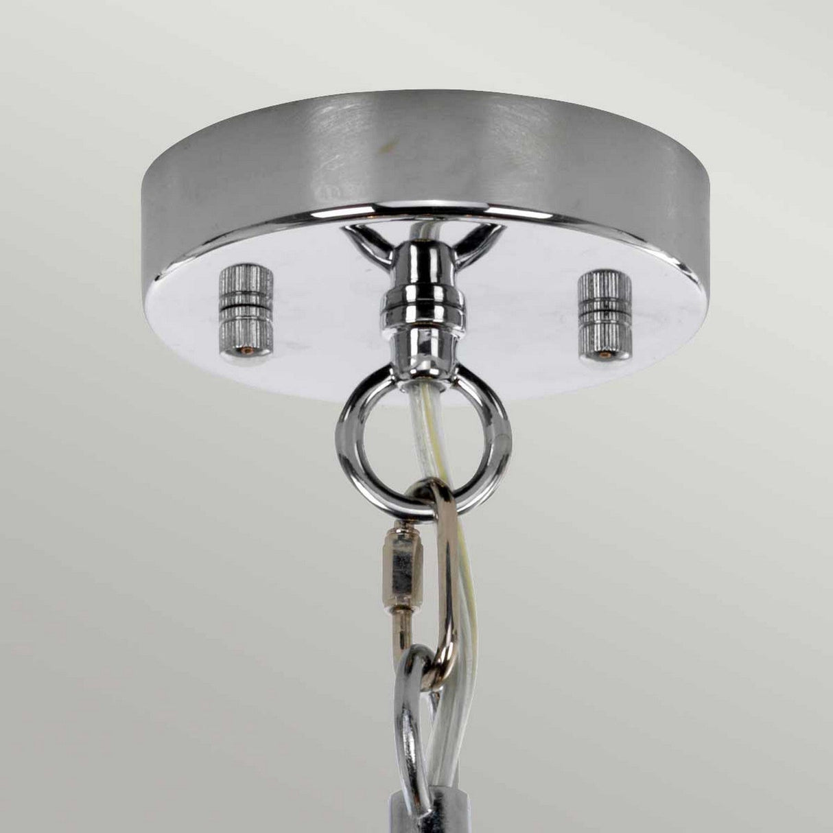 Close-up of a ceiling mount with a round canopy, resembling the Shoal 1 Light Pendant - Polished Nickel. Chains and wires are attached, designed to support a contemporary-style hanging fixture. The polished nickel base appears reflective and slightly glossy against a light gray background.