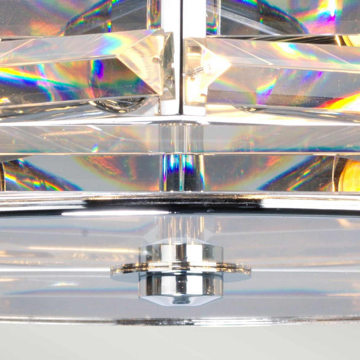 A detailed view of a contemporary chandelier showcases prism-like, intertwining crystals that refract colorful light. These crystals are geometrically arranged around a central polished nickel fixture, producing a lively and reflective pattern characteristic of the Shoal 4 Light Flush - Polished Nickel design.