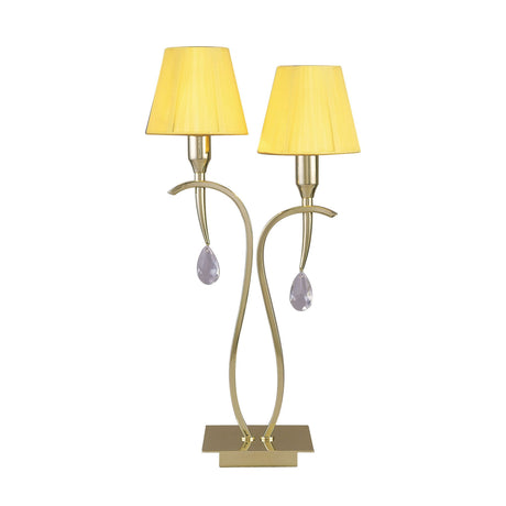 The Siena 2 Light Crystal Table Lamp features curved brass stems, two amber shades, clear teardrop ornaments, and a rectangular gold base—ideal for adding elegant ambient lighting to any room.