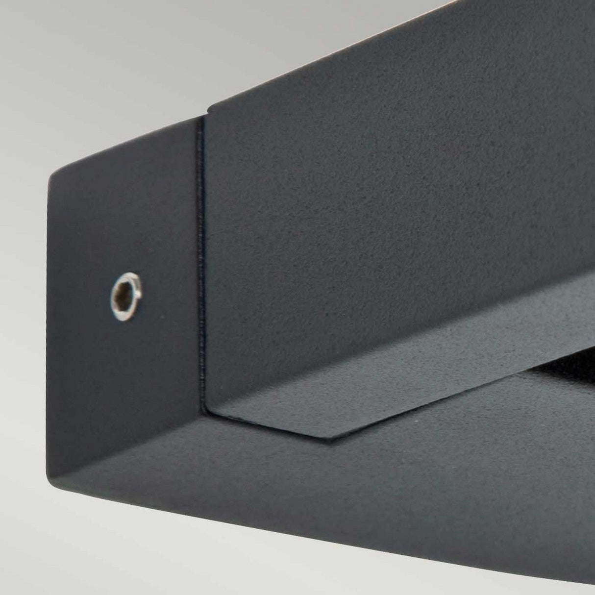 Close-up of the Sigmund 3 Light Outdoor Wall Light in a sleek graphite finish against a light gray background. This modern, minimalist wall bracket showcases clean lines and visible screws, complemented by rotatable LED modules for versatile illumination.