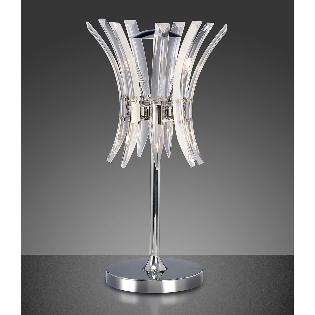 The Sinclair 4 Light Crystal Table Lamp in polished chrome features a shiny base and stand with curved, transparent acrylic pieces in a floral design—ideal for adding contemporary style to any room. Shown against a gradient gray background.