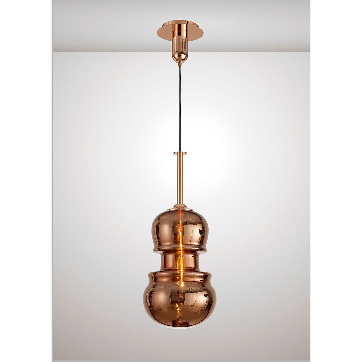 Mantra Sonata 29cm pendant light with hand-blown copper glass shade in a stacked double-bulb silhouette, suspended from a copper canopy on a black cord.