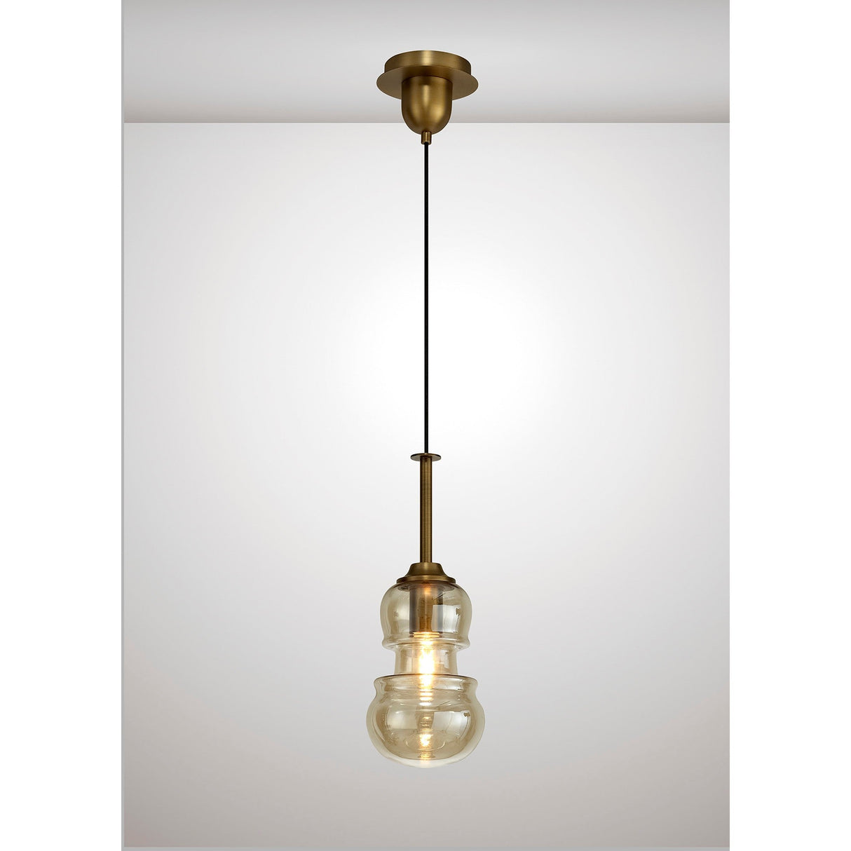 Mantra Sonata 1 Light pendant with hand-blown bronze tinted glass in a double-gourd shape, suspended from an antique brass rod and canopy.