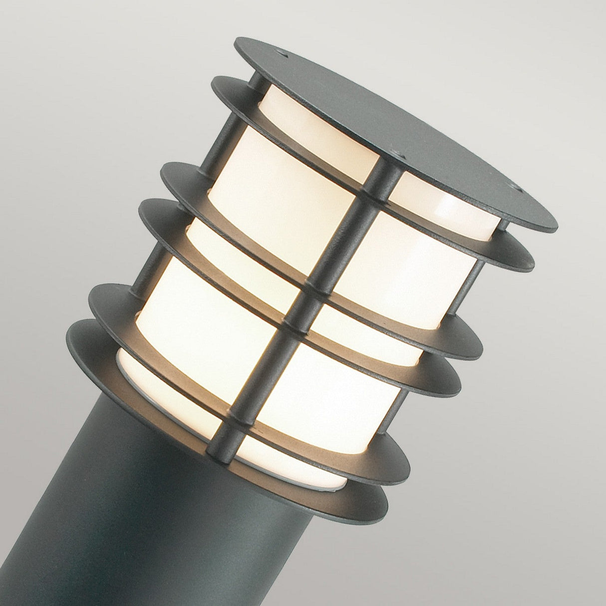 Elevate your outdoor space with the Stockholm 1 Light Large Bollard - Black, a contemporary lighting solution crafted from galvanized steel. This modern fixture features a cylindrical design with three illuminated sections accented by metal bands, perfect for complementing any neutral backdrop.