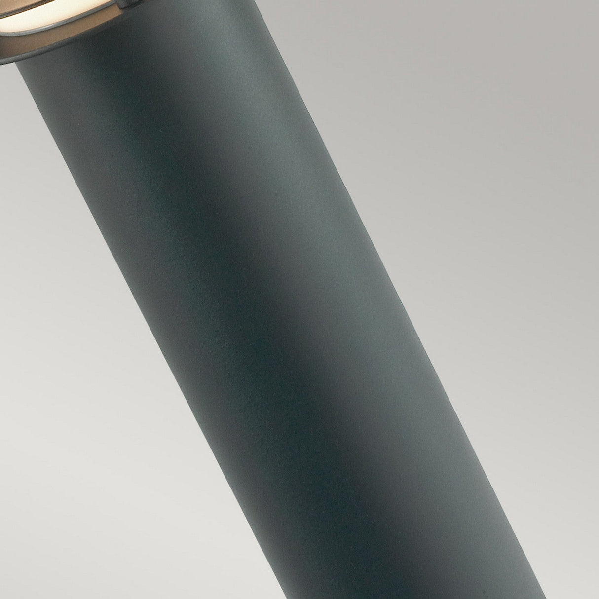 Close-up of the sleek, cylindrical Stockholm 1 Light Large Bollard in black, featuring a slightly angled, flat light-colored top against a light gray background. Crafted from galvanized steel, this object doubles as stylish outdoor lighting.