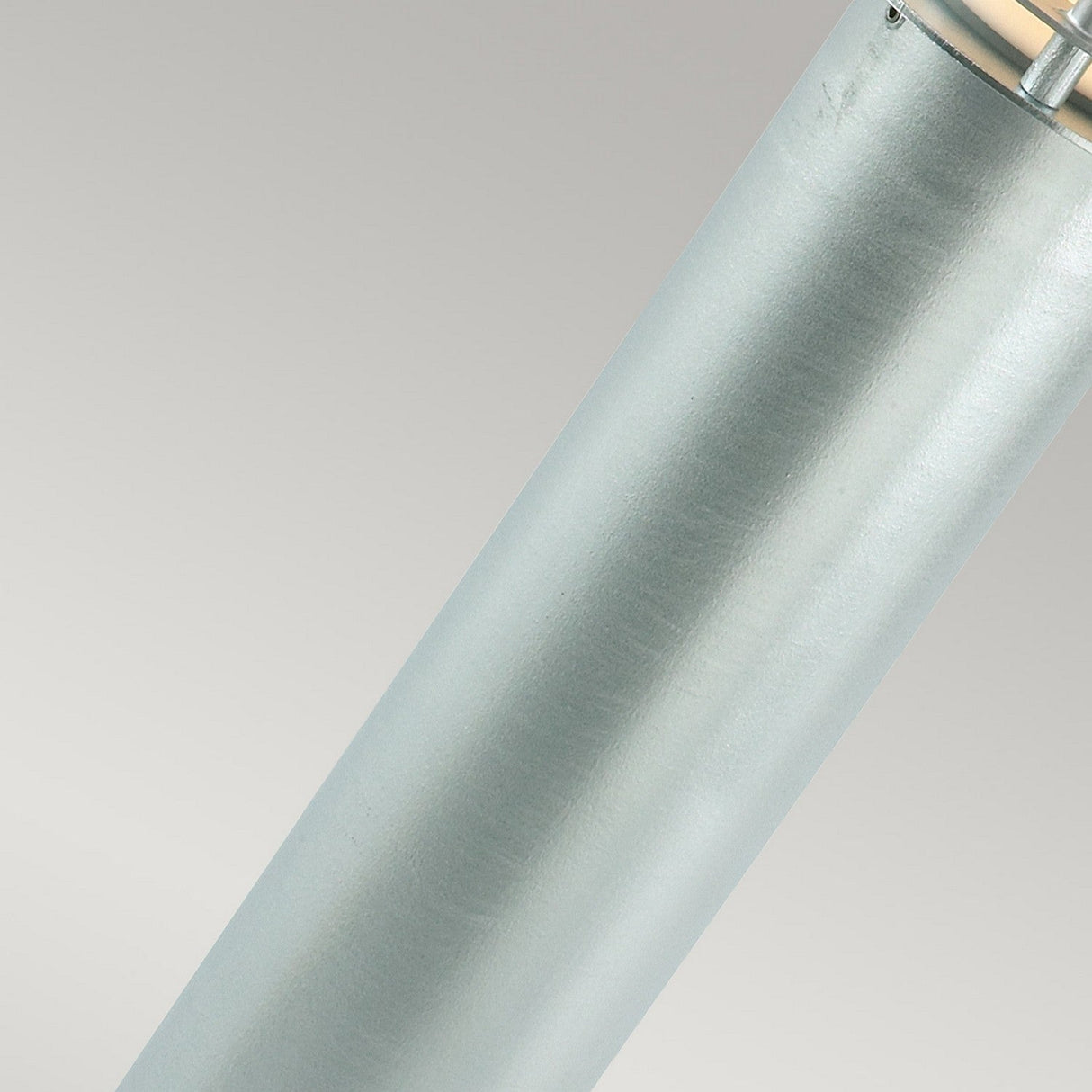Close-up of the Stockholm Large Bollard - Silver, a metallic cylindrical object with a smooth silver finish set against a light gray background. The top features a shiny section with visible components, indicating its function as industrial or outdoor lighting.