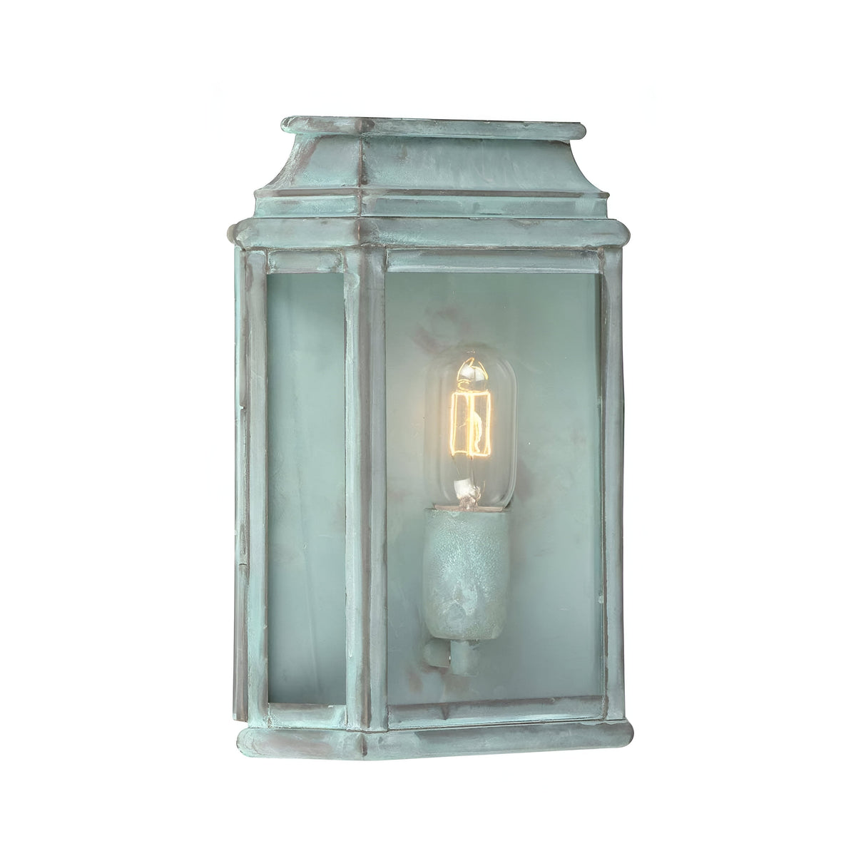 The St Martins 1 Light Outdoor Wall Light - Verdigris showcases a vintage-style lantern with a delightful verdigris finish, clear glass panel, and an exposed bulb inside. Its classic rectangular design makes it an ideal choice for solid brass lighting in both outdoor wall settings or indoor decoration.
