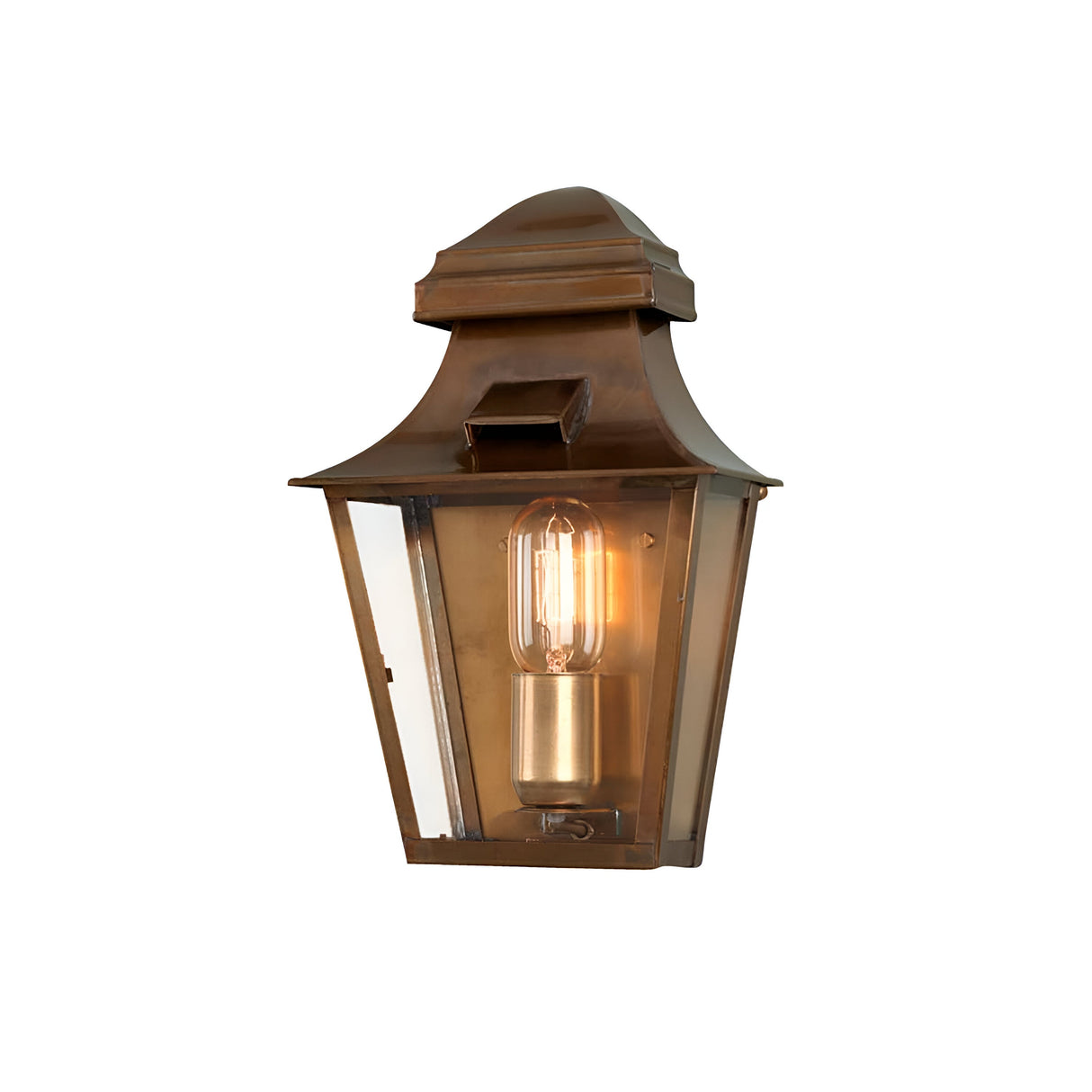 The St Pauls 1 Light Outdoor Wall Light - Aged Brass showcases a vintage-inspired design with a rectangular glass enclosure that houses a glowing light bulb, creating a warm ambiance. It features an IP44 rating and is mounted on a flat, bronze backplate, ensuring durability and style for any setting.