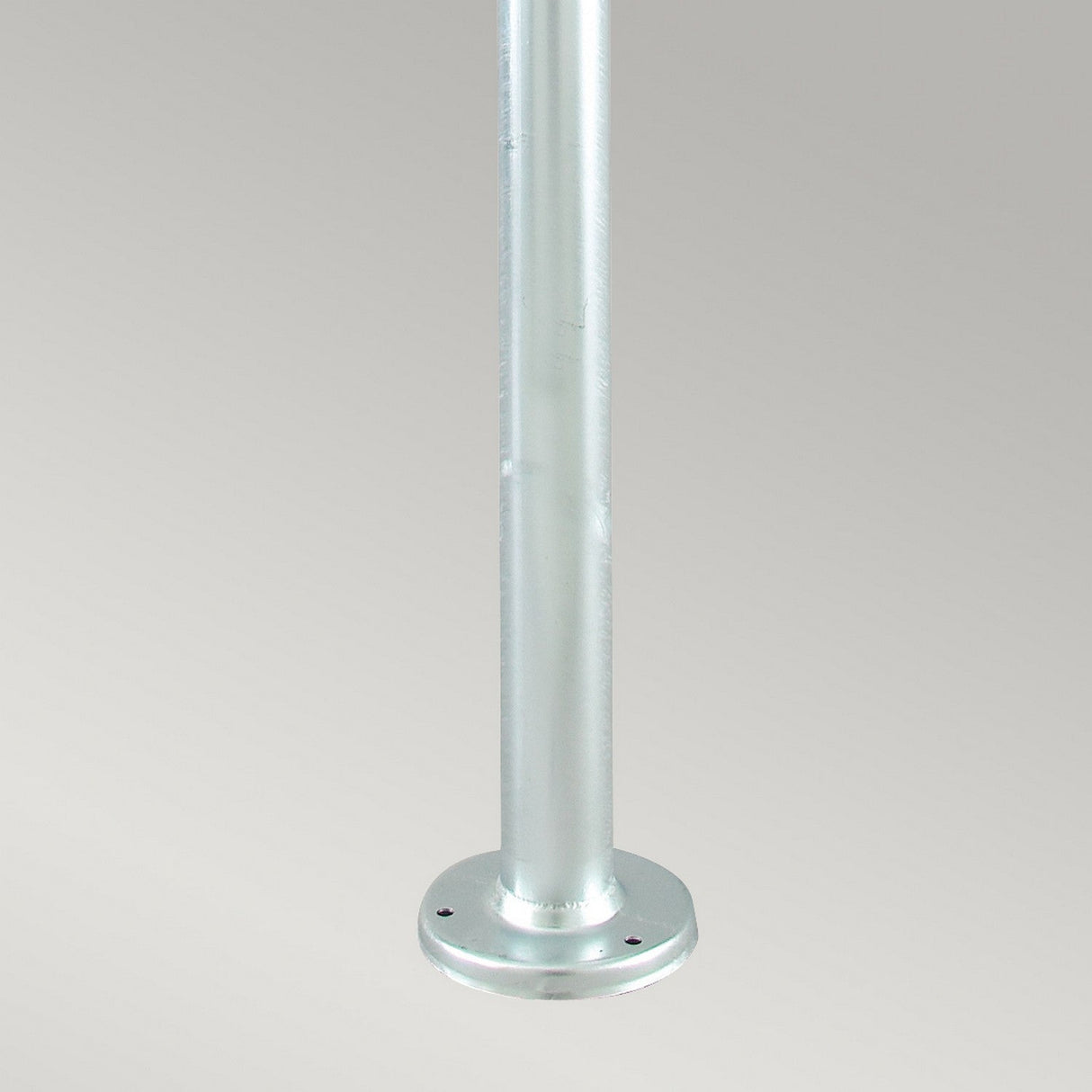 A vertical metallic pole crafted from galvanized steel with a round base at the bottom, set against a neutral gray background. Its Scandinavian-inspired design echoes simplicity and functionality, reminiscent of the Stockholm 2 Light Twin Lamp Post - Silver.