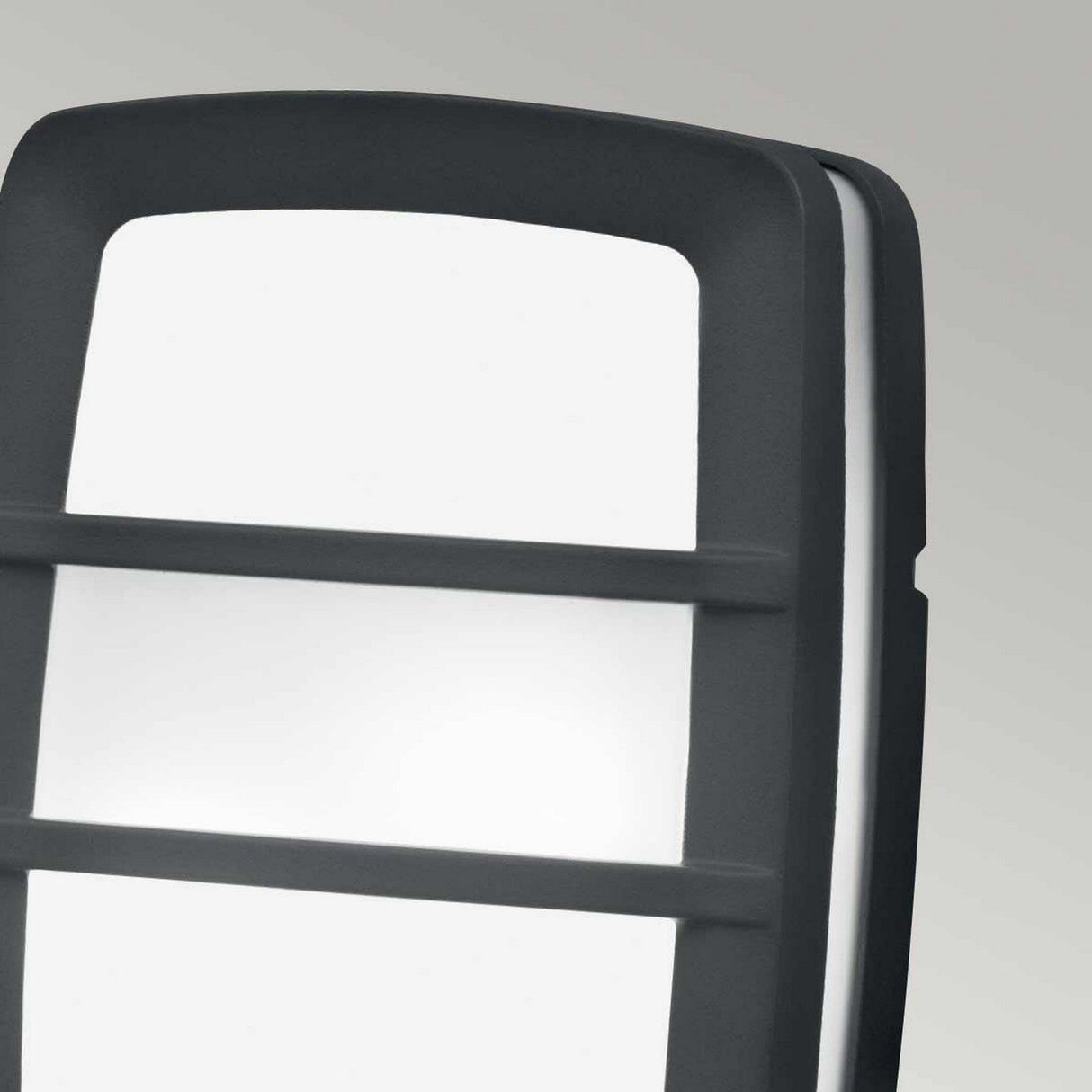 Close-up of the Sven 2 Light Outdoor Wall/Ceiling Light in graphite, showcasing a modern design crafted from durable die-cast aluminium. It features a black frame with frosted glass panels, shaped rectangularly and accented by two horizontal bars across the front.