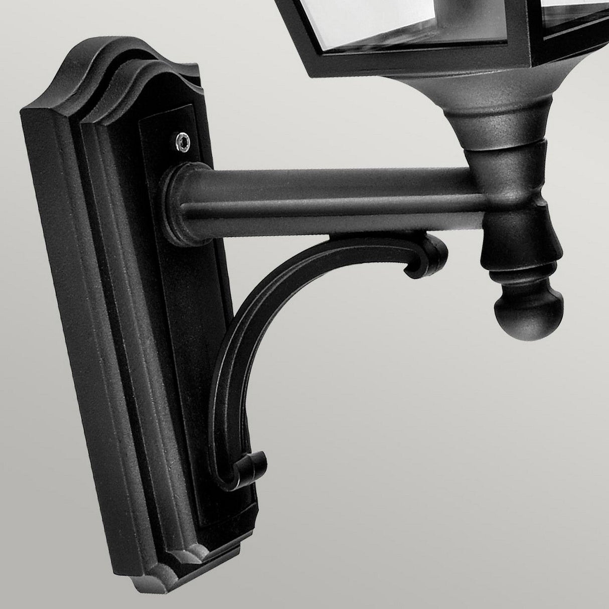 The Turin Outdoor 1 Light Up Wall Lantern - Black showcases a sophisticated curved arm and intricate base, constructed from sturdy die-cast aluminum. With its IP54 rating, this lantern promises durability against the elements while adding a touch of elegance to any neutral setting.