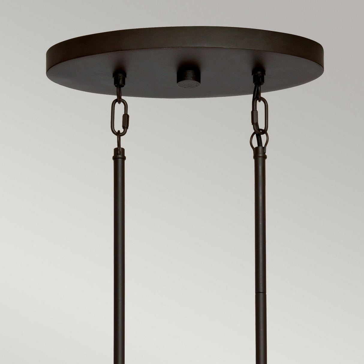 A close-up view of an Olde Bronze ceiling canopy and rods with two adjustable chains highlights the simple, industrial design that complements the Taiko 5 Light Island Suspension Light, set against a neutral background.