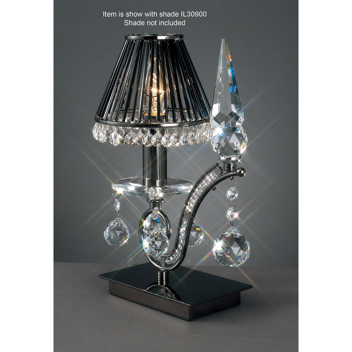 The Tara 1 Light Crystal Table Lamp - Black Chrome features a black wire shade, hanging crystal accents, and a clear spire on a shiny black chrome base, creating bright, sparkling reflections as an elegant decorative lighting piece.