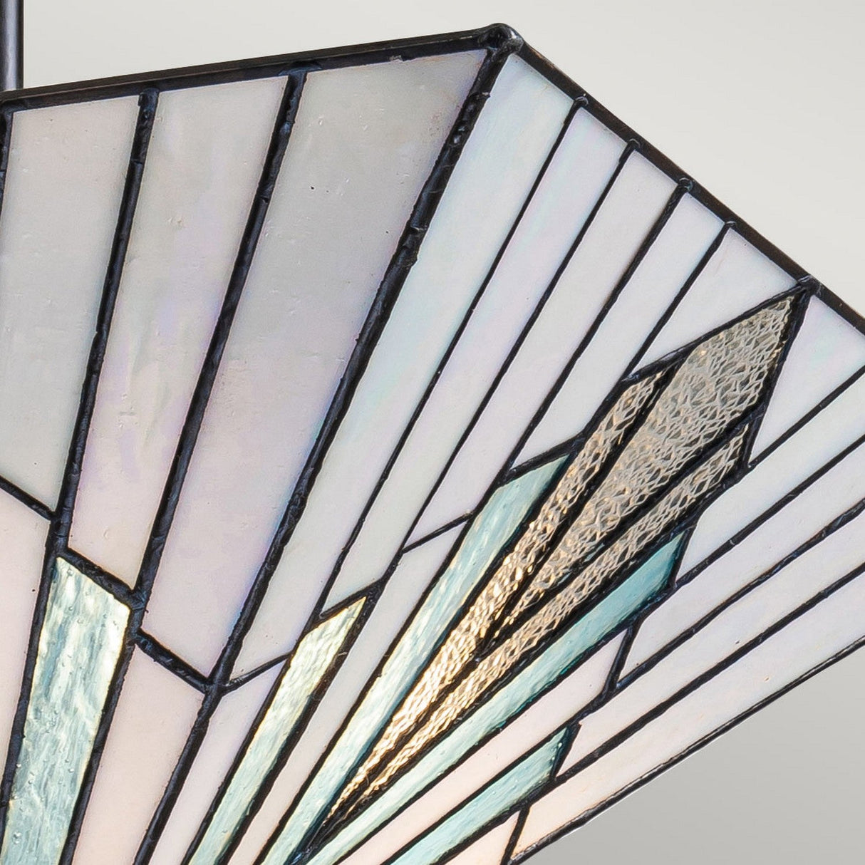 Close-up of the Alderley 2 Light Trio Mount Tiffany Pendant in vintage bronze, showcasing its geometric stained glass lampshade in white, light blue, and cream. The fan-like design adds a subtle shimmer and lends an artistic Art Deco flair to the piece.