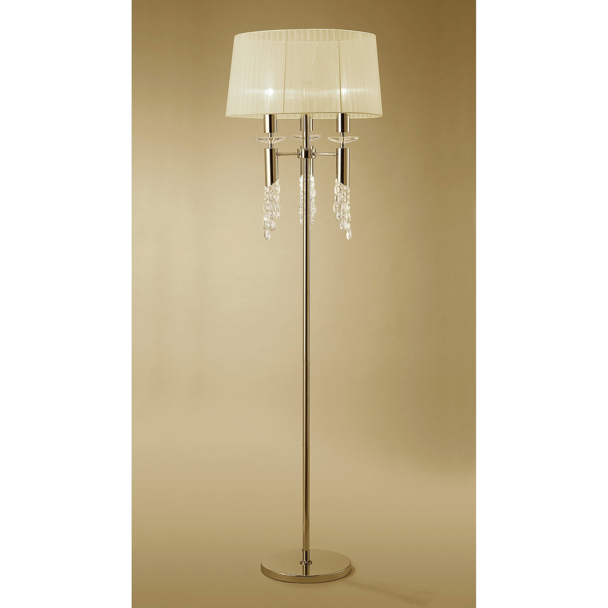 The Tiffany 6 Light Crystal Floor Lamp features a slim gold stand, cream round shade, and elegant crystal accents, set against a neutral beige background.