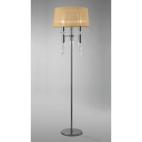 The Tiffany 6 Light Crystal Floor Lamp features a shiny chrome stand, a round bronze shade, and crystal-like accents hanging below the shade, displayed against a plain gray background.