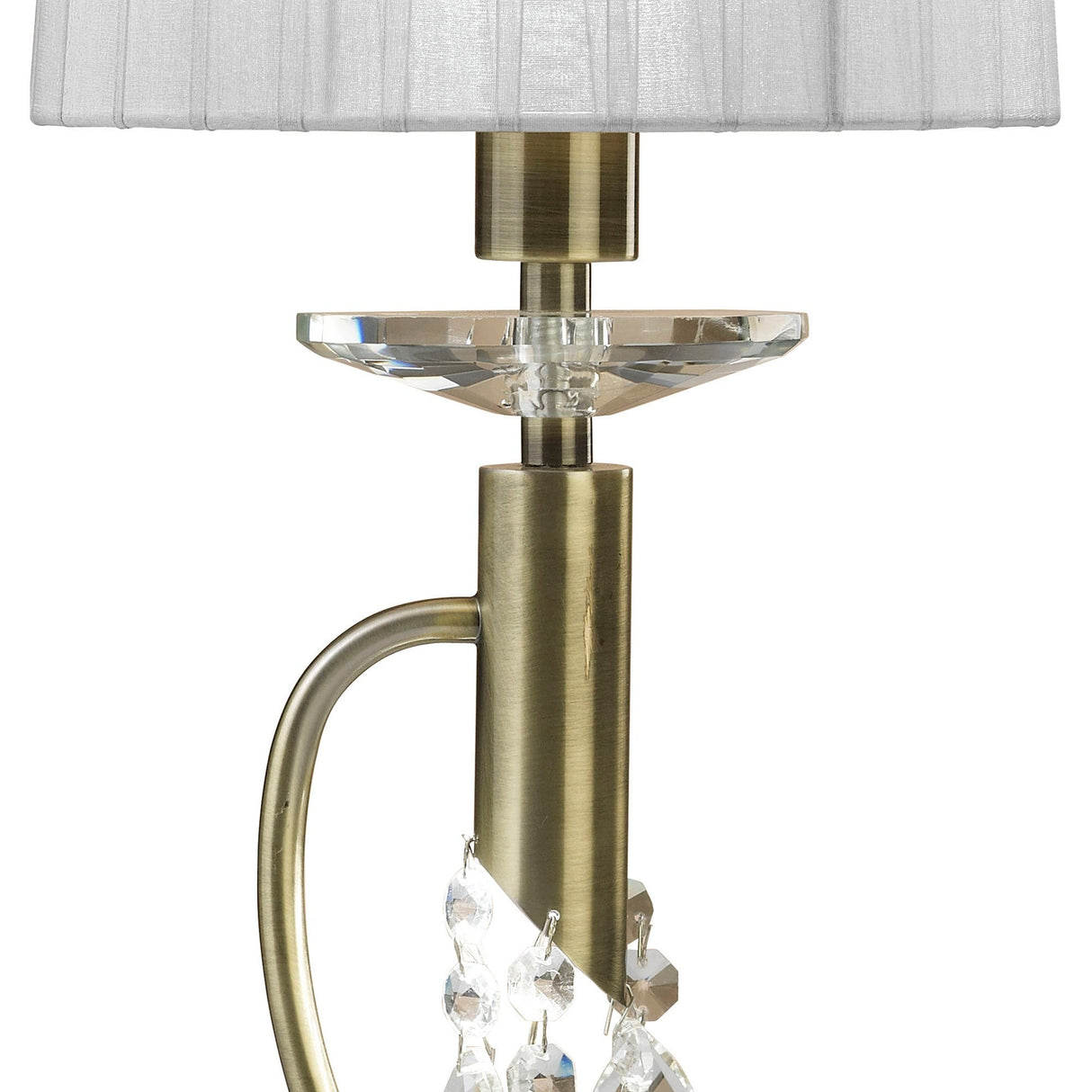 A close-up of the Tiffany 2 Light Crystal Table Lamp features an antique brass base, round crystal accent, hanging crystal ornaments, and a white pleated shade for an elegant touch.