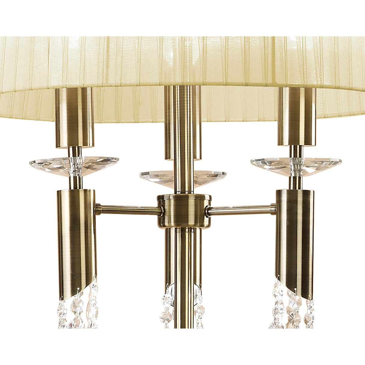 Close-up of the Tiffany 6 Light Crystal Floor Lamp in brass, featuring a cream pleated shade and crystal accents, with six candle-style lights elegantly arranged around a central metallic rod.
