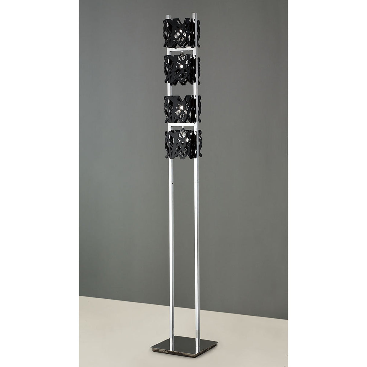 The Tokio 4 Light Floor Lamp – Gloss Black & Polished Chrome features a sleek chrome frame and three black cut-out shades, delivering modern ambient lighting with contemporary style.