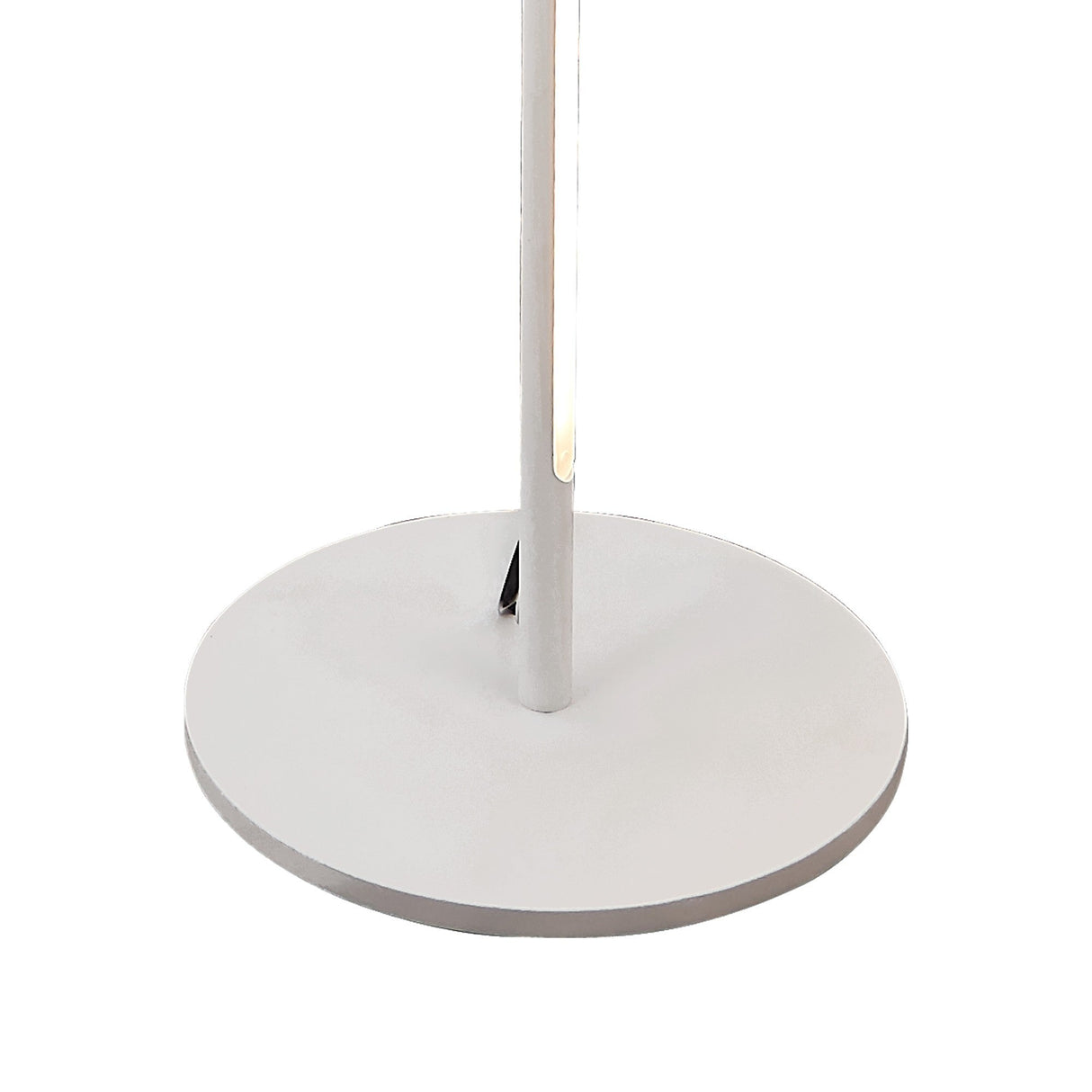 A close-up of the Tsunami LED Floor Lamp 25W 3000K - Sand White shows its round, flat white base with a vertical pole attached at the center.