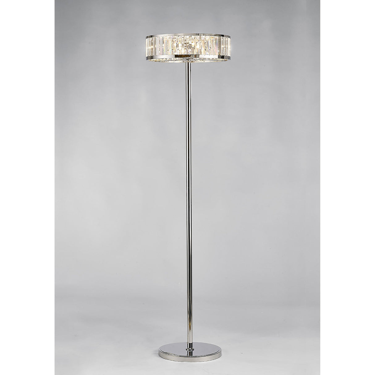 The Torre 5 Light Crystal Floor Lamp in polished chrome features a round shade with clear vertical crystal accents for ambient lighting, set against a plain light gray background.