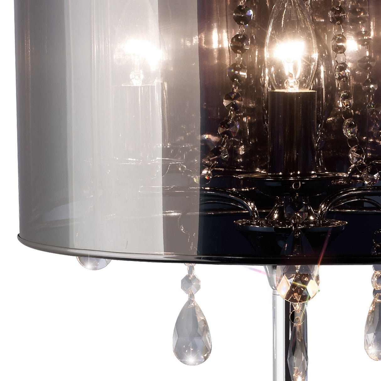 Close-up of the Trace 3 Light Crystal Table Lamp in chrome, featuring a chrome shade with crystal droplets and a glowing bulb that casts warm, reflective crystal accent lighting.