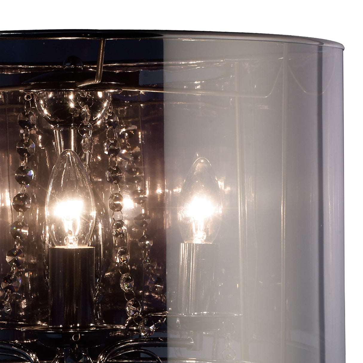 Close-up of the Trace 3 Light Crystal Table Lamp in chrome, featuring a glowing bulb with crystal accents and a cylindrical chrome shade. The reflections create a modern, elegant look.