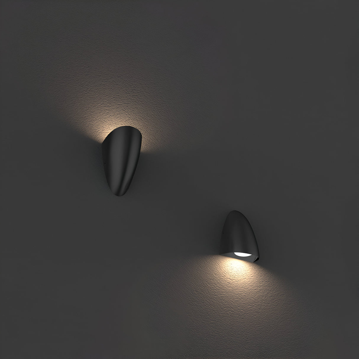 Two Vendela Outdoor LED Wall Lights in black illuminate a dark gray wall. The upper light emits a soft, upward glow, while the lower one casts a gentle downward illumination, creating a warm and minimalist ambiance with energy-efficient lighting.