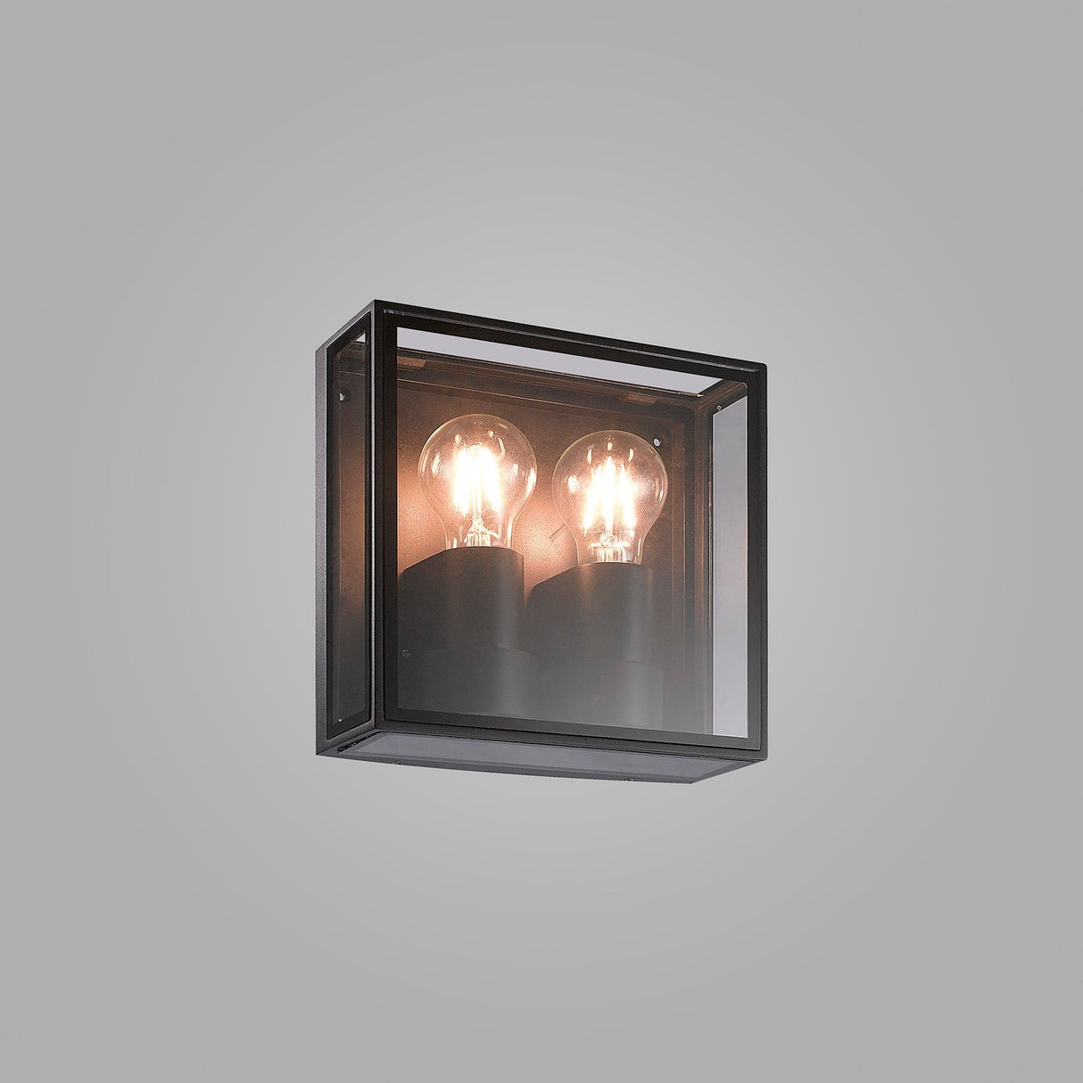 Mantra Verbier 2 light outdoor wall light in anthracite, square metal frame with clear glass panels and two lit E27 bulbs, on a grey background.