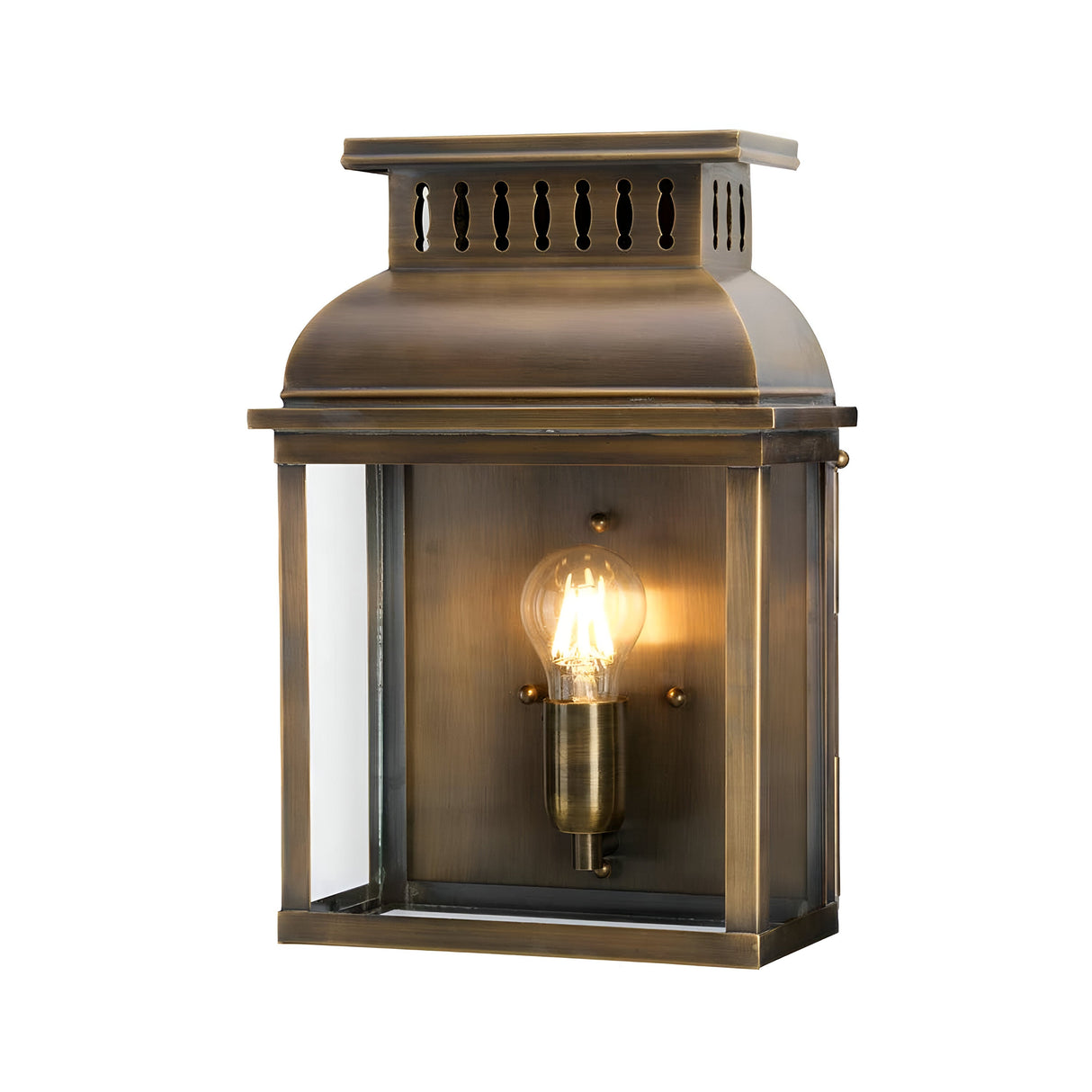 Introducing the Westminster 1 Light Outdoor Wall Light - Aged Brass, an exquisite fixture that blends vintage charm with its elegant bronze finish and aged brass accents. It boasts a clear glass panel with an exposed glowing bulb, enhanced by decorative vents on top for a touch of timeless elegance.