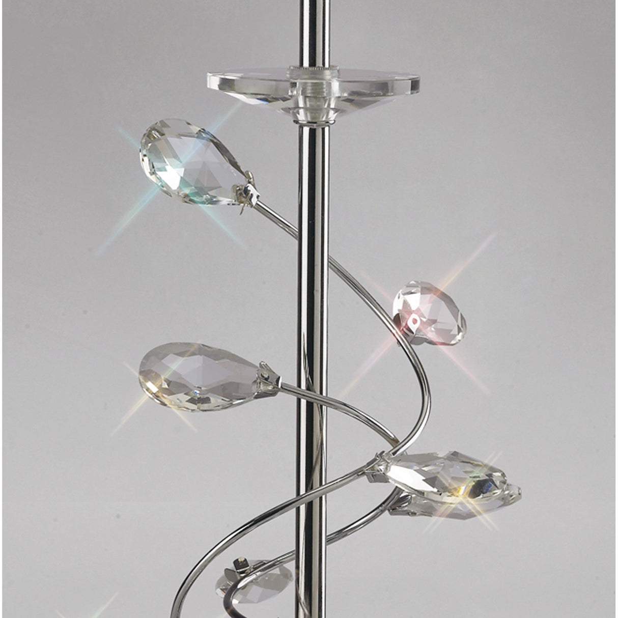 A close-up of the Willow 1 Light Crystal Table Lamp in chrome, featuring spiral arms with clear crystal accents and a white shade that reflect light to create colorful sparkles.