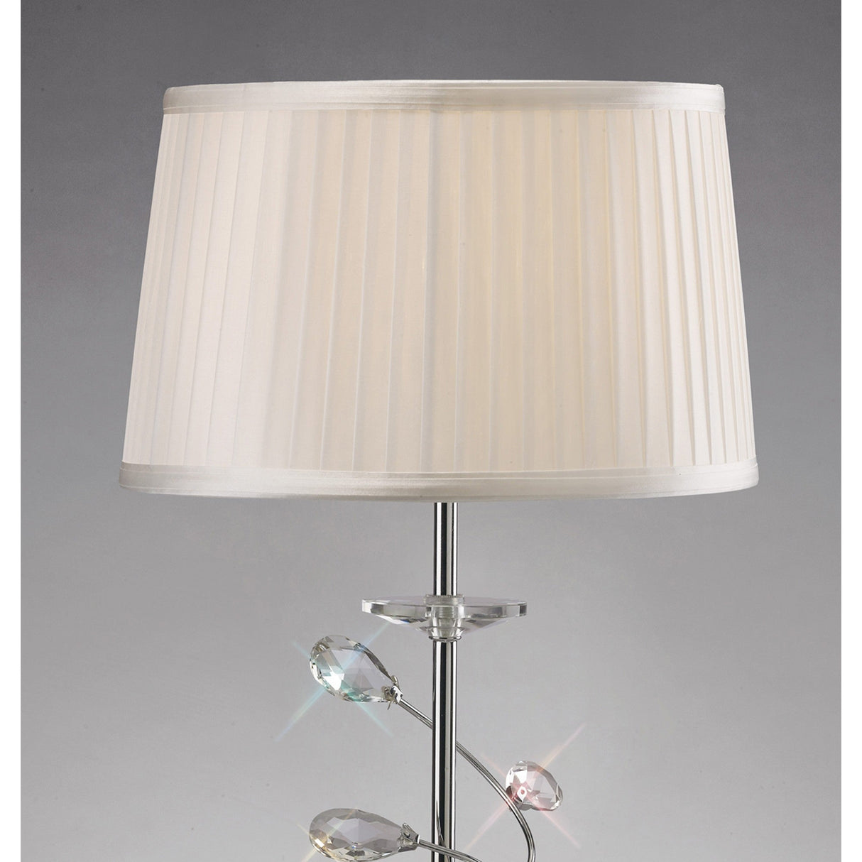 The Willow 1 Light Crystal Table Lamp features a chrome finish, clear crystal accents, and a white pleated shade, displayed against a plain gray background.