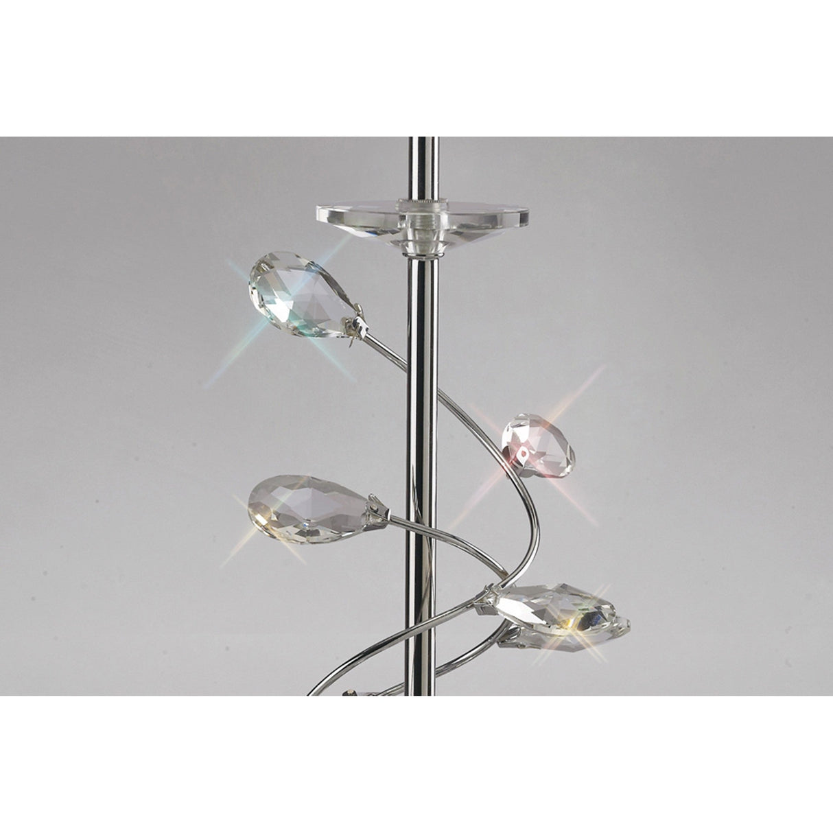 Close-up of the Willow 1 Light Crystal Table Lamp in chrome, featuring spiral metal arms with faceted crystal drops that reflect light and cast small rainbows, paired with a cream shade against a plain gray background.