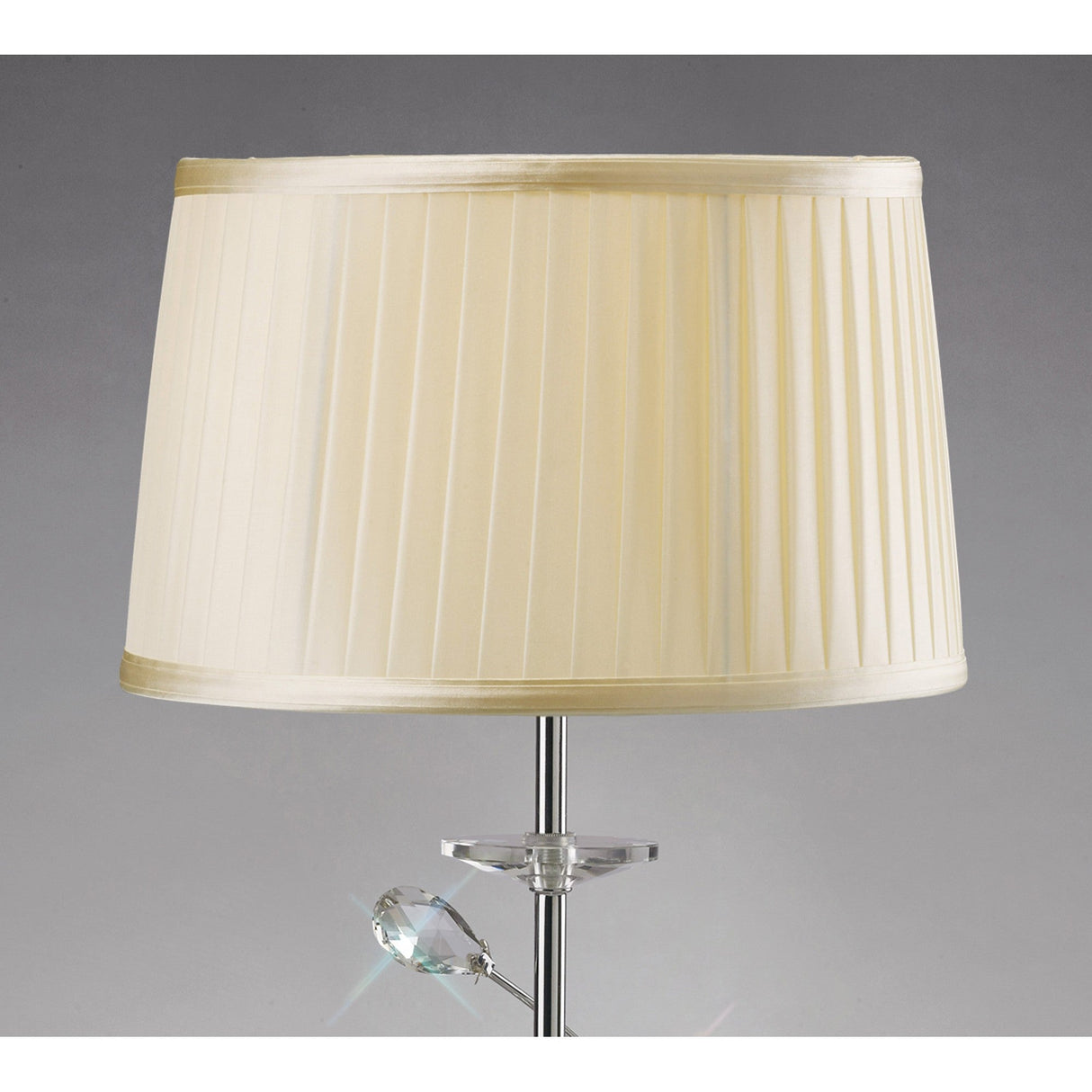 The Willow 1 Light Crystal Table Lamp features a chrome base with a decorative crystal accent and is topped with a cream pleated shade, shown against a plain gray background.