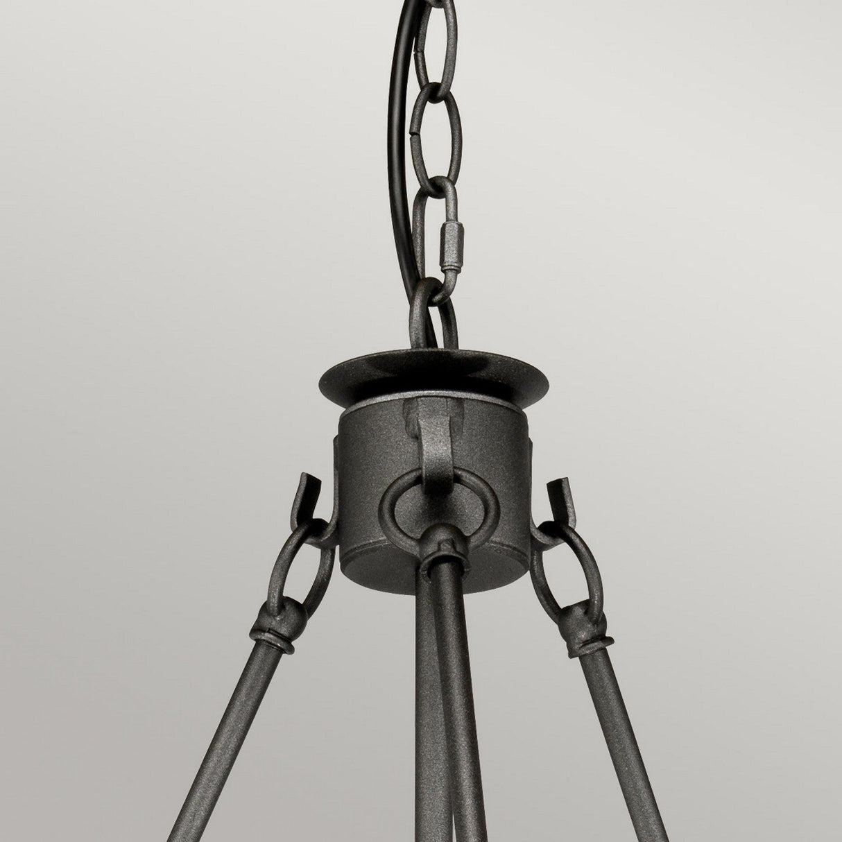A close-up of the Windsor 6 Light Chandelier - Graphite, featuring its black metal construction with a graphite finish and chain link design. Three elegant rods converge at a central point against a simple light gray background.