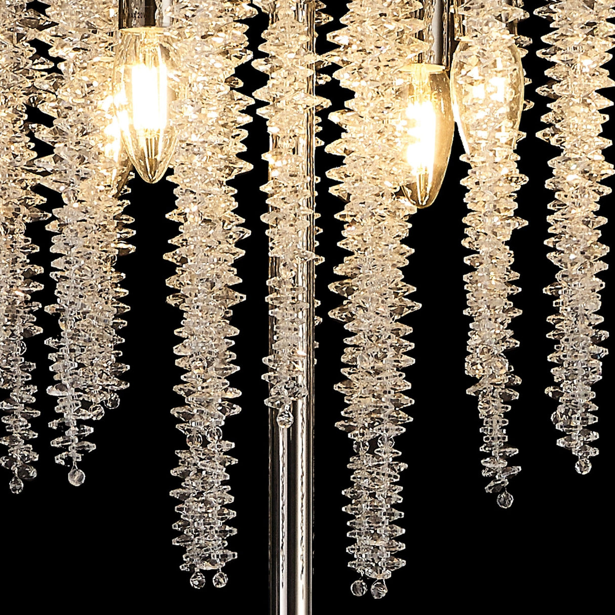 Close-up of the Wisteria 4 Light Crystal Floor Lamp, featuring cascading crystal clusters and exposed bulbs suspended from a polished nickel frame, set against a black background.