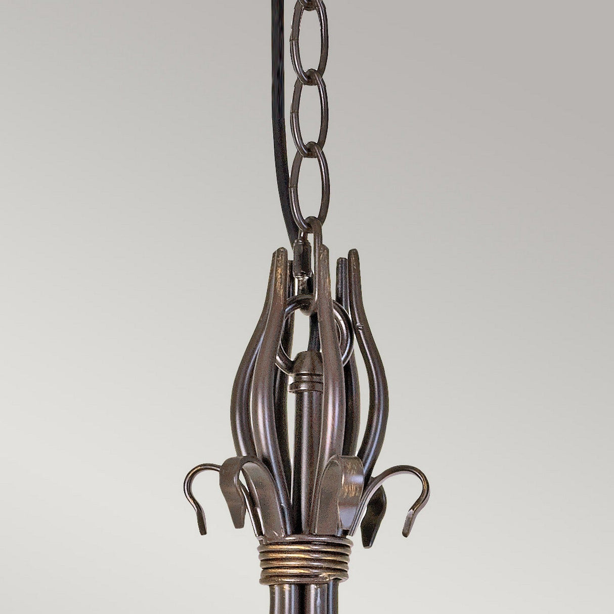 The Windermere 6 Light Chandelier in a rust and gold finish boasts a handcrafted design with curved metal arms and decorative hooks, elegantly hanging from a chain against a plain background.