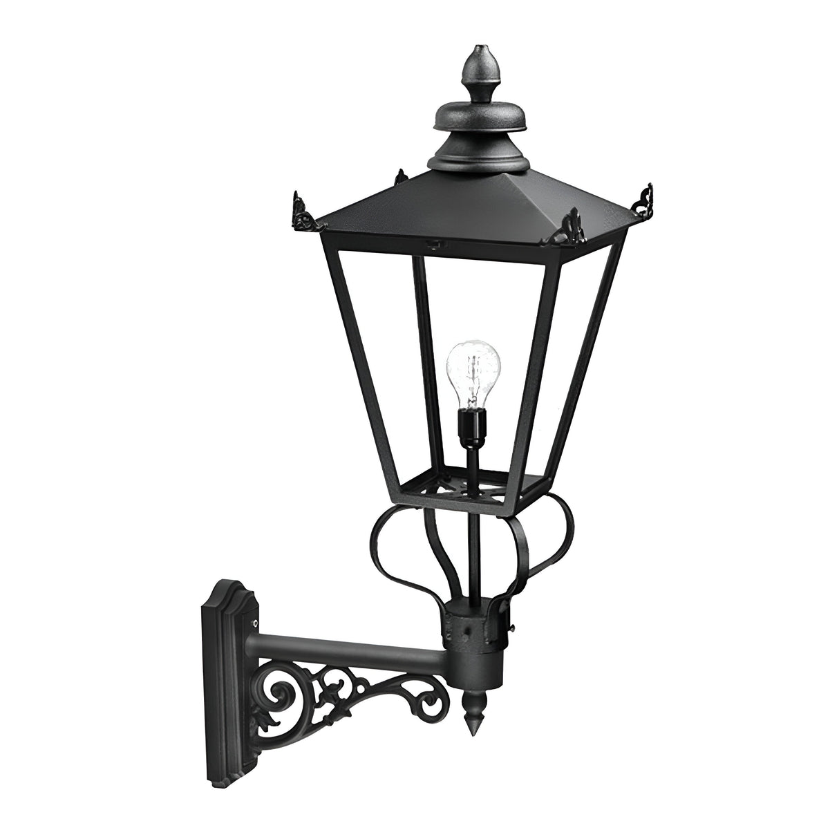 The Wilmslow 1 Light Outdoor Wall Light in black boasts a vintage-style reminiscent of Victorian street lamps, featuring an ornate bracket. This weather-resistant outdoor fixture includes a clear bulb housed beneath a pyramid-shaped roof, making it perfect for enhancing exterior decor with its intricate, classic design.