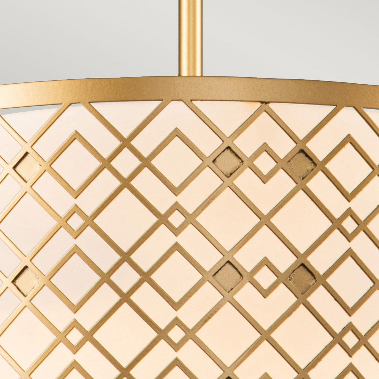 Close-up of the Ziggy 2 Light Duo-Mount Medium Pendant/Semi-Flush in a lacquered gold finish, showcasing a contemporary design with geometric patterns. The adjustable height fixture features overlapping diamond shapes set against a light background, offering a modern and sophisticated appearance.