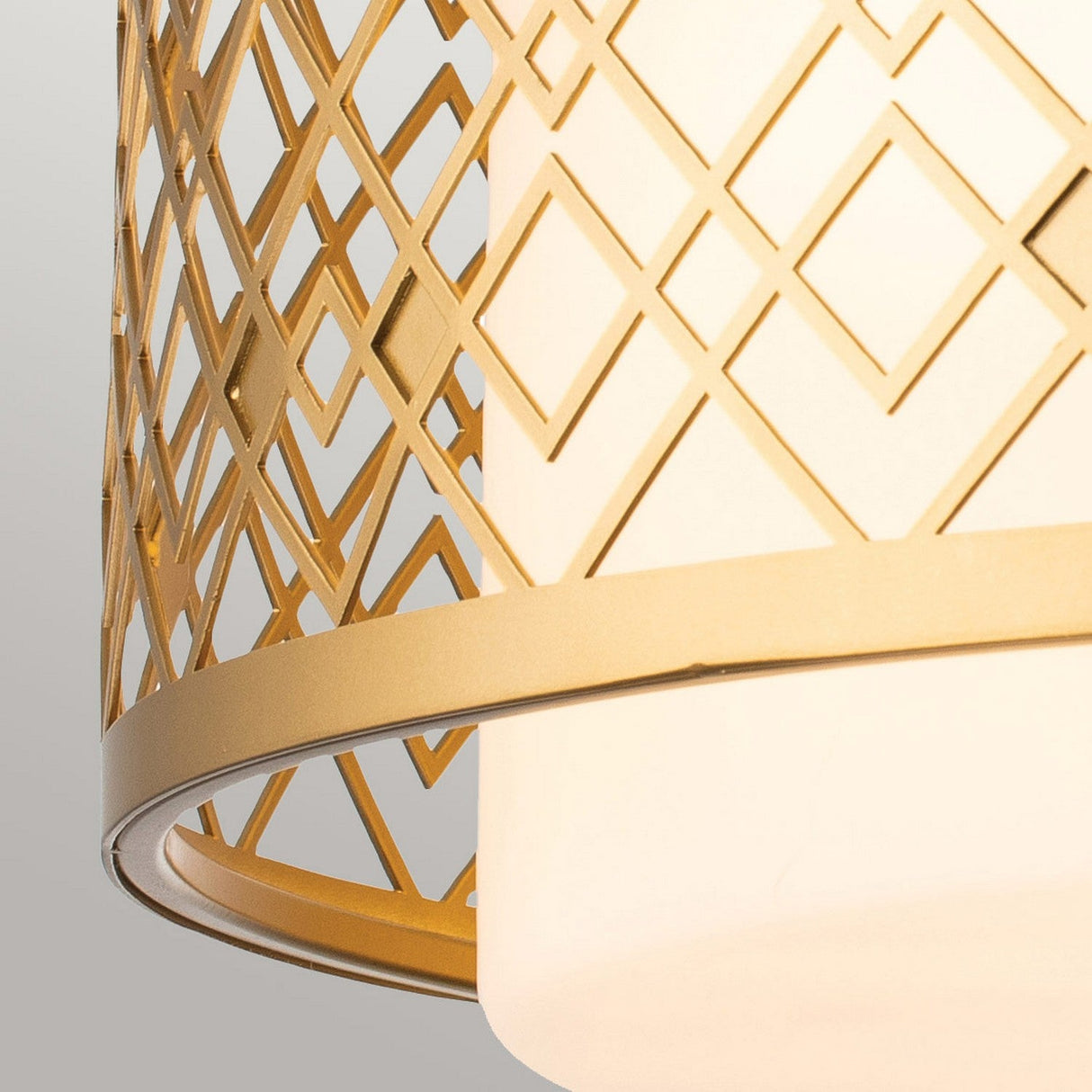 Close-up of a Ziggy 2 Light Medium Flush - Lacquered Gold ceiling light featuring a geometric lattice design. The light shines through the crisscross pattern, creating a warm, contemporary look and elegant ambiance.