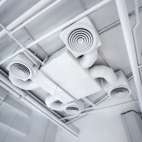 Portable white air cooler with louvered vents, a sleek design, and four caster wheels for easy mobility.