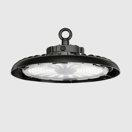 A black circular industrial LED high bay light with a metal hook for hanging. The light has a ribbed design and emits bright, even illumination.