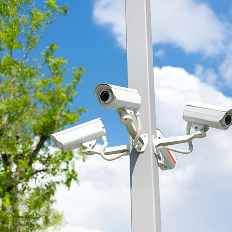 A white Hikvision security camera with a sleek, modern design, featuring a black lens.