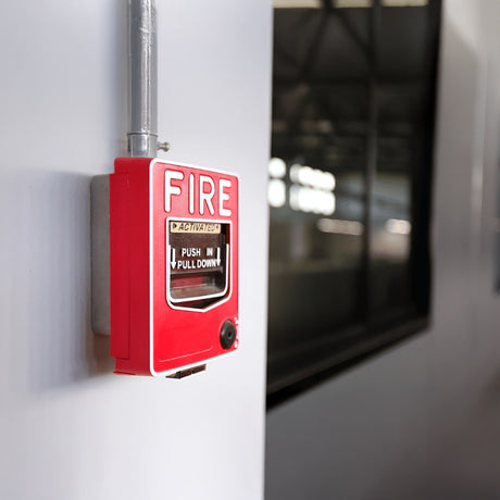 Box of MAGfire fire alarm kit, showing components like detectors, alarm panel, and other accessories, with red and white design. Branding includes ESP logo and website URL.
