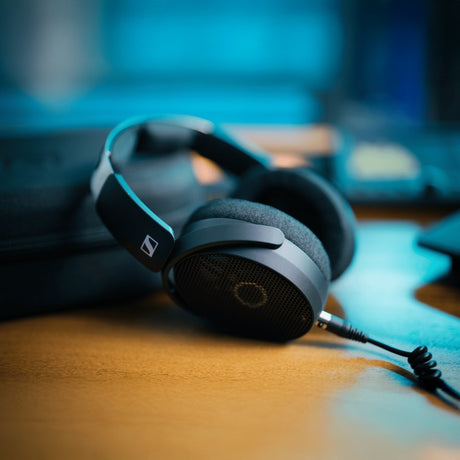 Black over-ear wireless headphones with padded ear cups and headband, facing forward. They have a sleek design and adjustable headband.