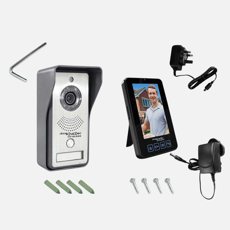 Silver rectangular video doorbell with a camera lens at the top and a circular button below. The brand name aperta is printed near the bottom. The design is sleek and modern.