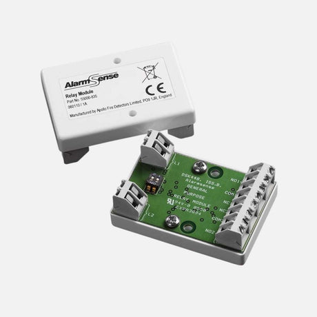 Close-up of a red fire alarm panel with a key switch. Text on the panel reads FIRE ALARM DO NOT SWITCH OFF. A central key slot is flanked by screws, with a green LED indicating POWER ON.