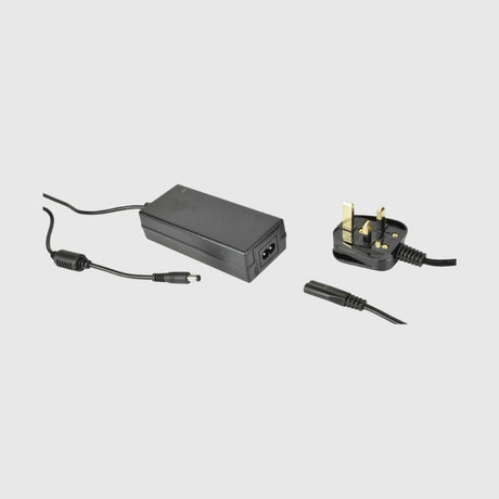 Black AC power adapter with detachable UK plug and connected low-voltage output cable.