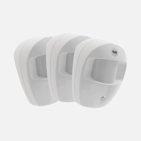 Set of three white PIR motion detectors.